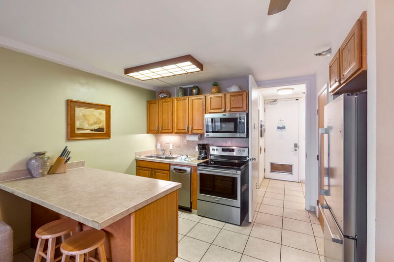Maui Kai 806 kitchen with island style decor and ocean views, fully equipped for vacation cooking
